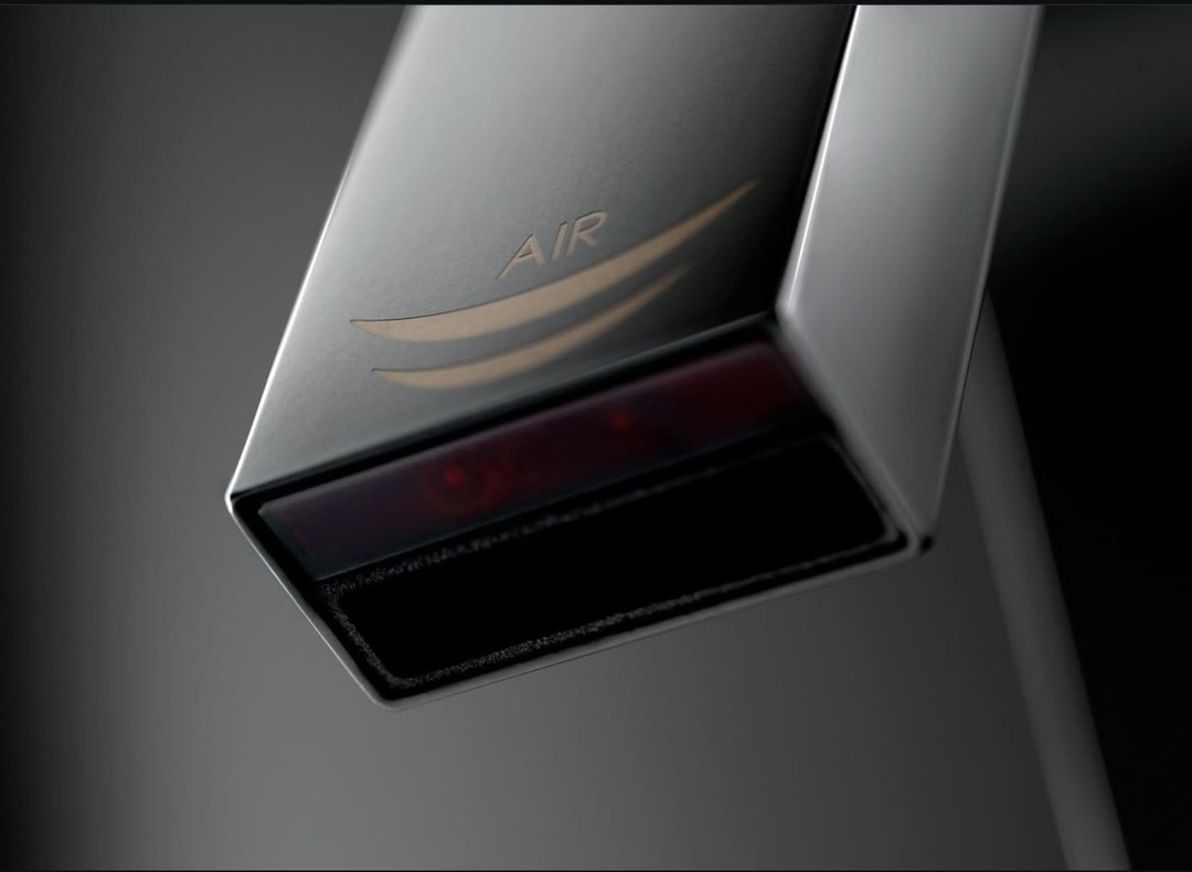 Touchless warm air hand dryer